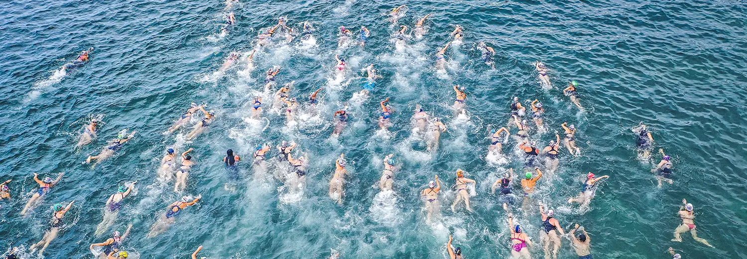 people swimming in the sea from above