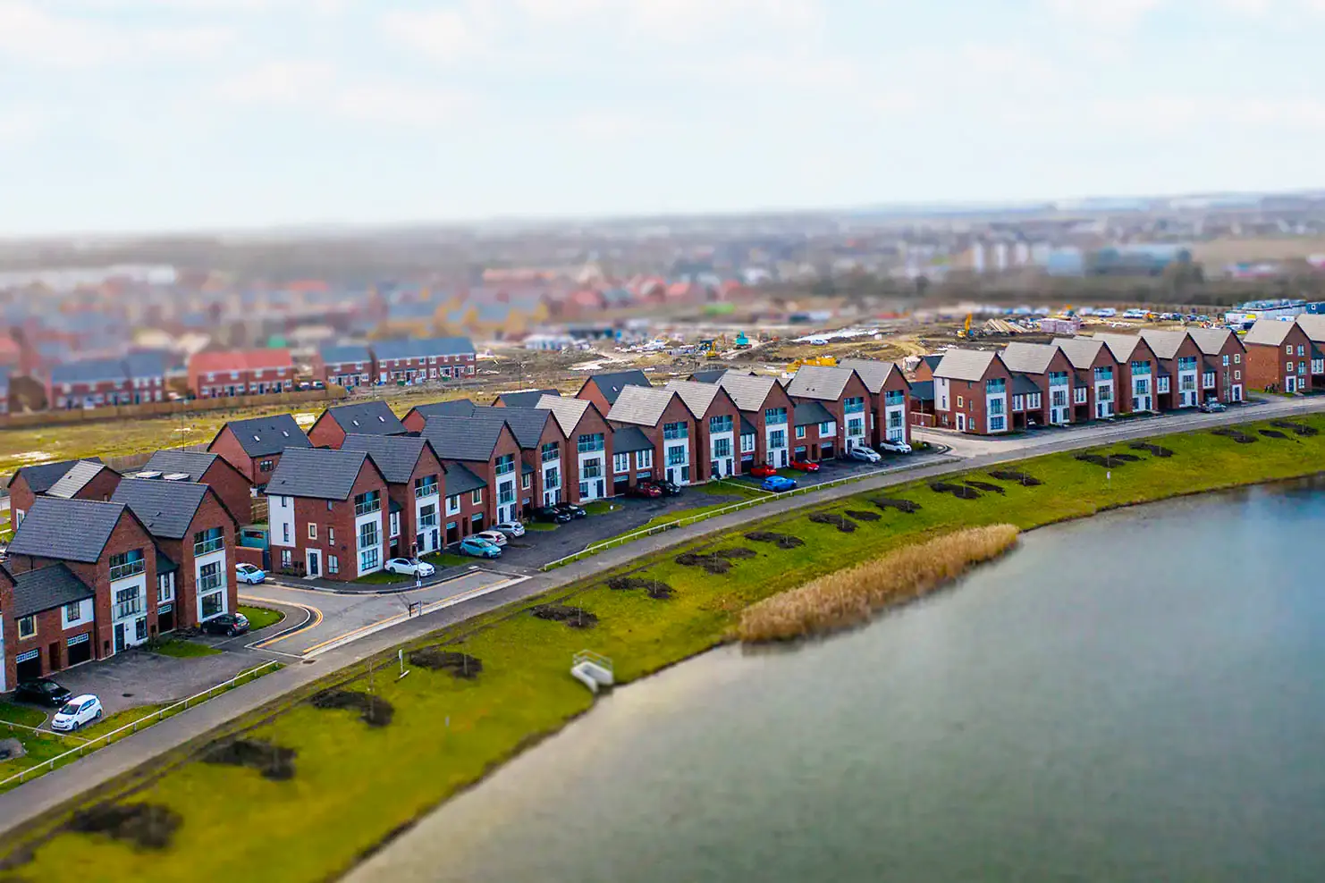 row of houses by lake drone view